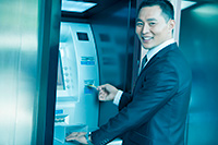 Customer smiling while using ATM serviced and sold by NJ NCR dealers