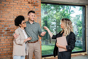 Buyers receiving keys from real estate agent after a quick sale of home that recently had duct cleaning in Ocean County