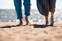 Couple walking on the beach after purchasing their dream home among the Seaside Park homes for sale.