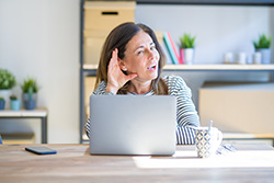 Homeowner hearing an odd sound and knowing they need to call for Monmouth County air conditioner repair.